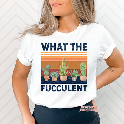 White unisex t-shirt featuring a funny "What the Fucculent" graphic with potted succulents, cactus, snake plant, and distressed vintage sunset stripes. A unique gift for plant moms, gardeners, and succulent fans.