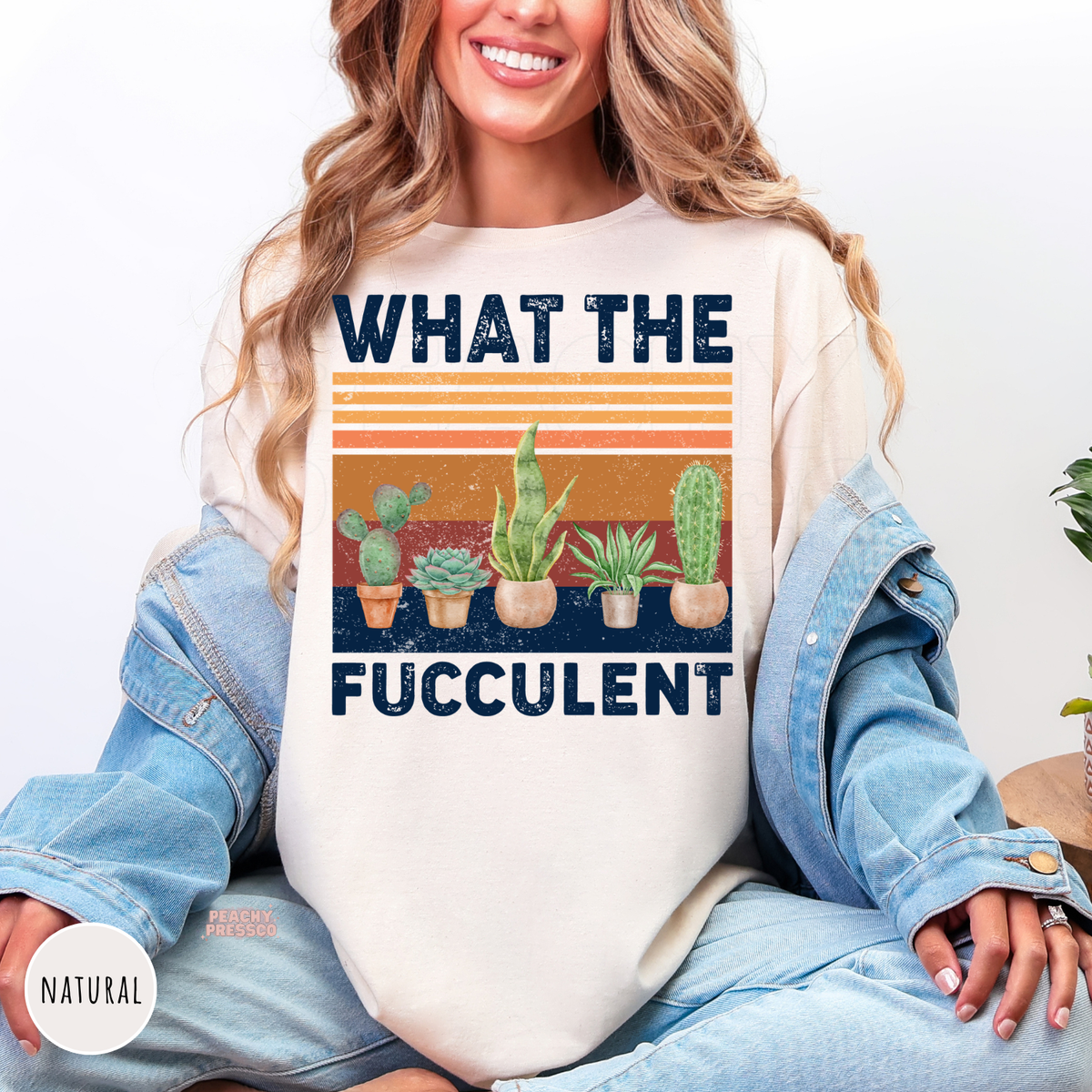 Natural unisex crewneck sweatshirt featuring a funny "What the Fucculent" graphic with cactus, succulent, snake plant, and houseplants on a retro vintage sunset background. Perfect sweatshirt for succulent lovers and plant enthusiasts.