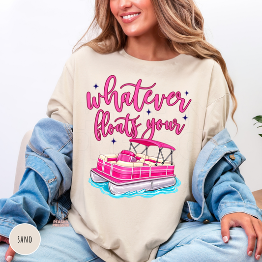 Sand crewneck sweatshirt featuring a bright pink pontoon boat with the phrase "Whatever Floats Your Boat." Cozy lake-inspired sweatshirt perfect for pontoon owners and summer evenings by the water.