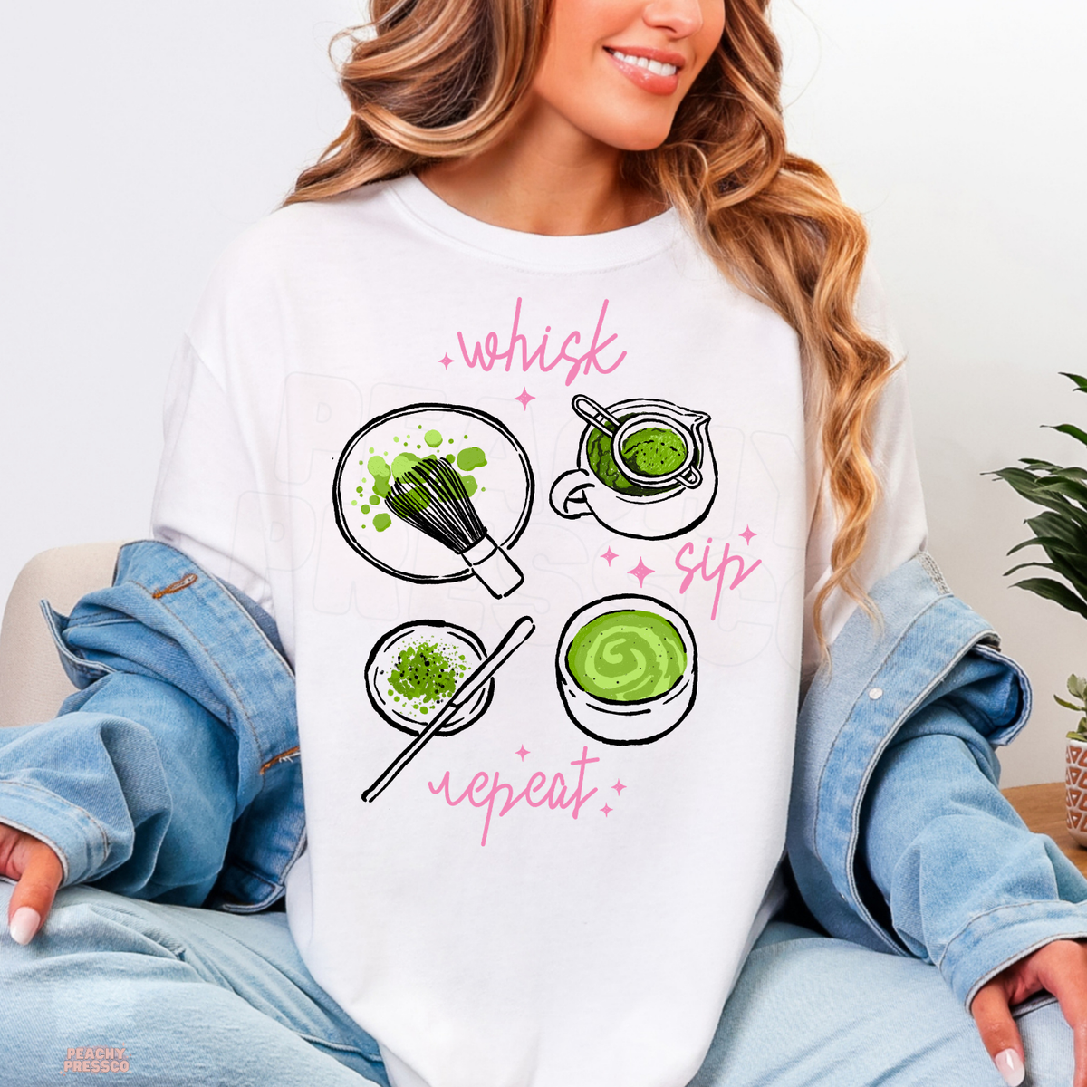 White Whisk Sip Repeat matcha shirt featuring hand-drawn matcha preparation illustrations, vibrant green tea, bamboo whisk, and pink sparkles.