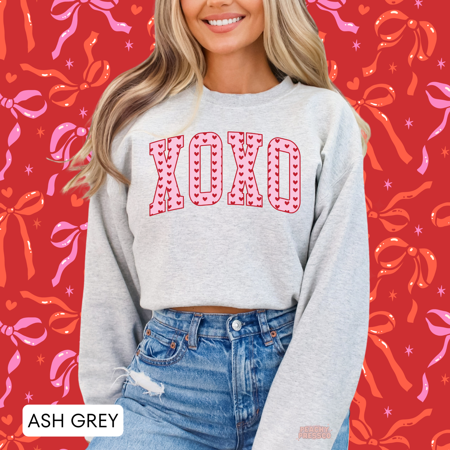 Ash grey crewneck sweatshirt with oversized XOXO varsity letters filled with red hearts for a trendy Valentine's Day outfit.