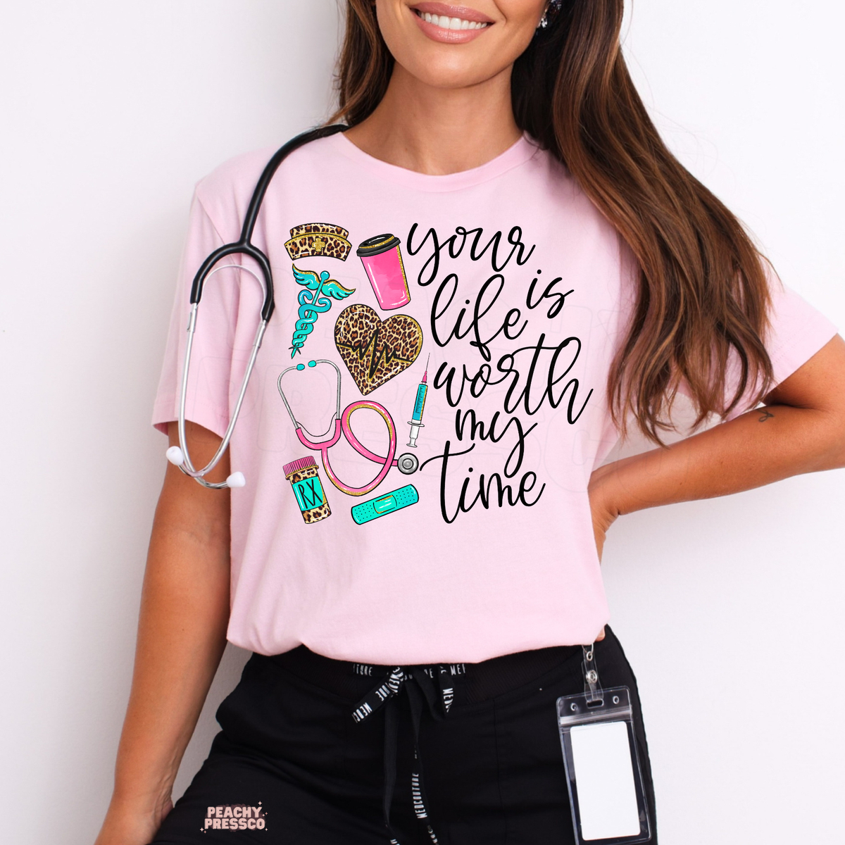 Light pink nurse T-shirt featuring Your Life Is Worth My Time quote, leopard print heart, pink stethoscope, coffee cup and turquoise medical accents.