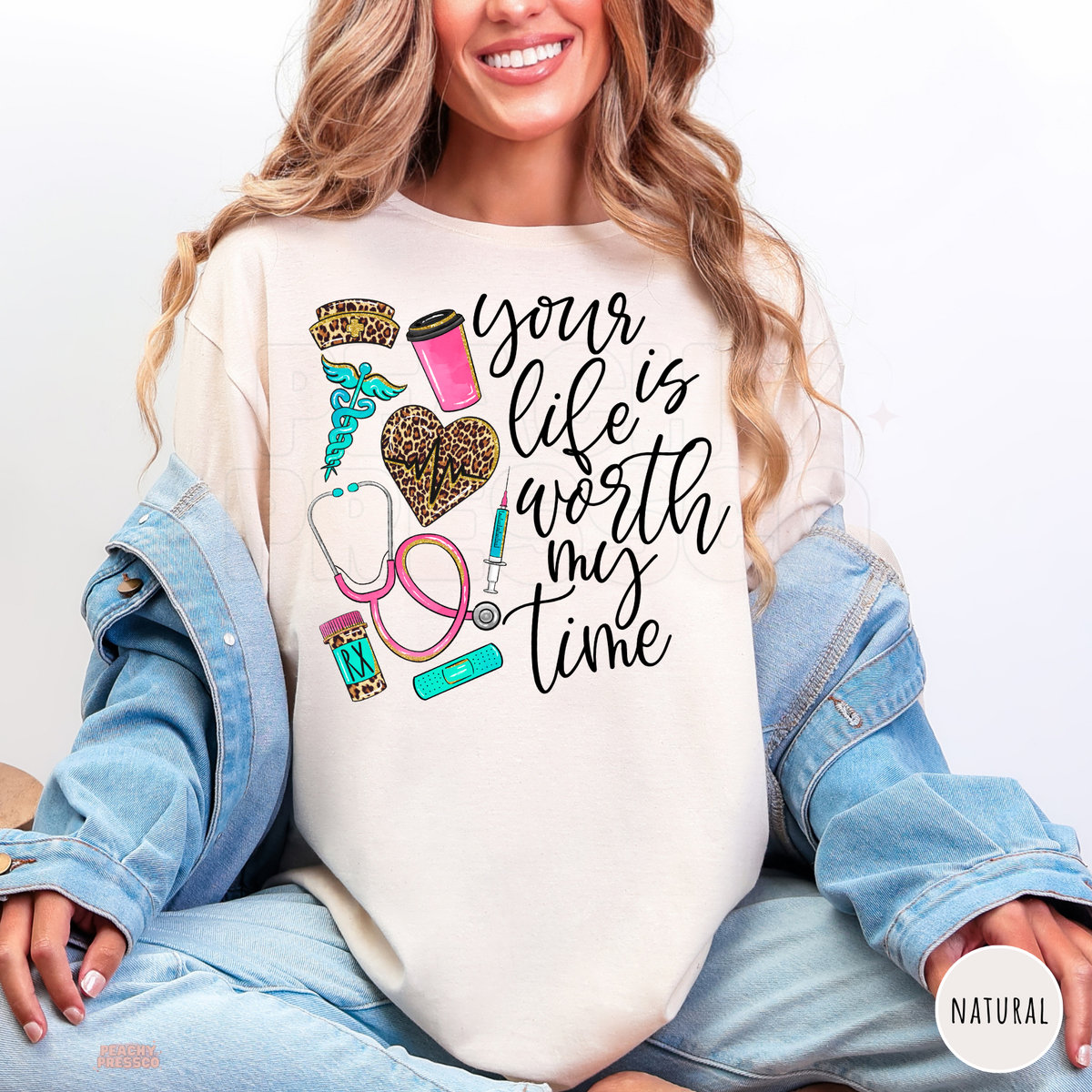 Natural nurse shirt featuring Your Life Is Worth My Time lettering, leopard heartbeat heart, pink coffee cup and nursing symbols.