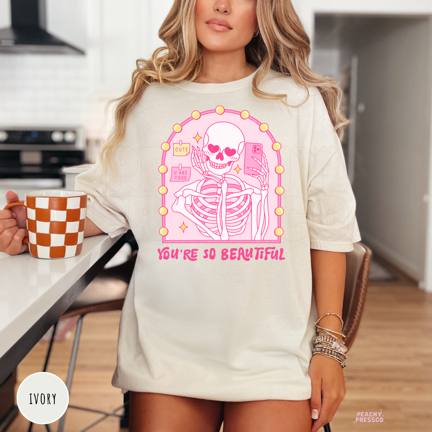 Ivory Comfort Colors t-shirt showcasing a cute pink skeleton taking a selfie with heart eyes and "You're So Beautiful" text for Valentine's Day.